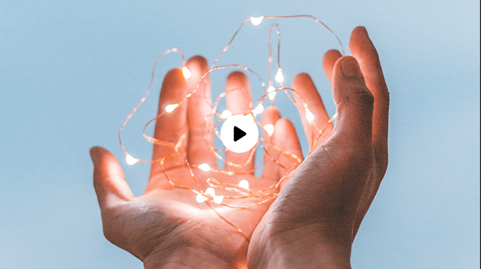 Hands holding glowing string lights