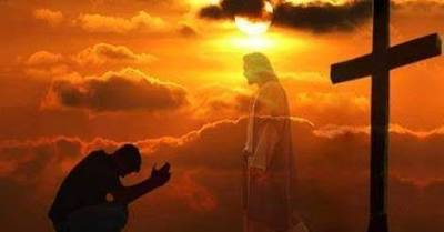Person praying before Jesus and cross